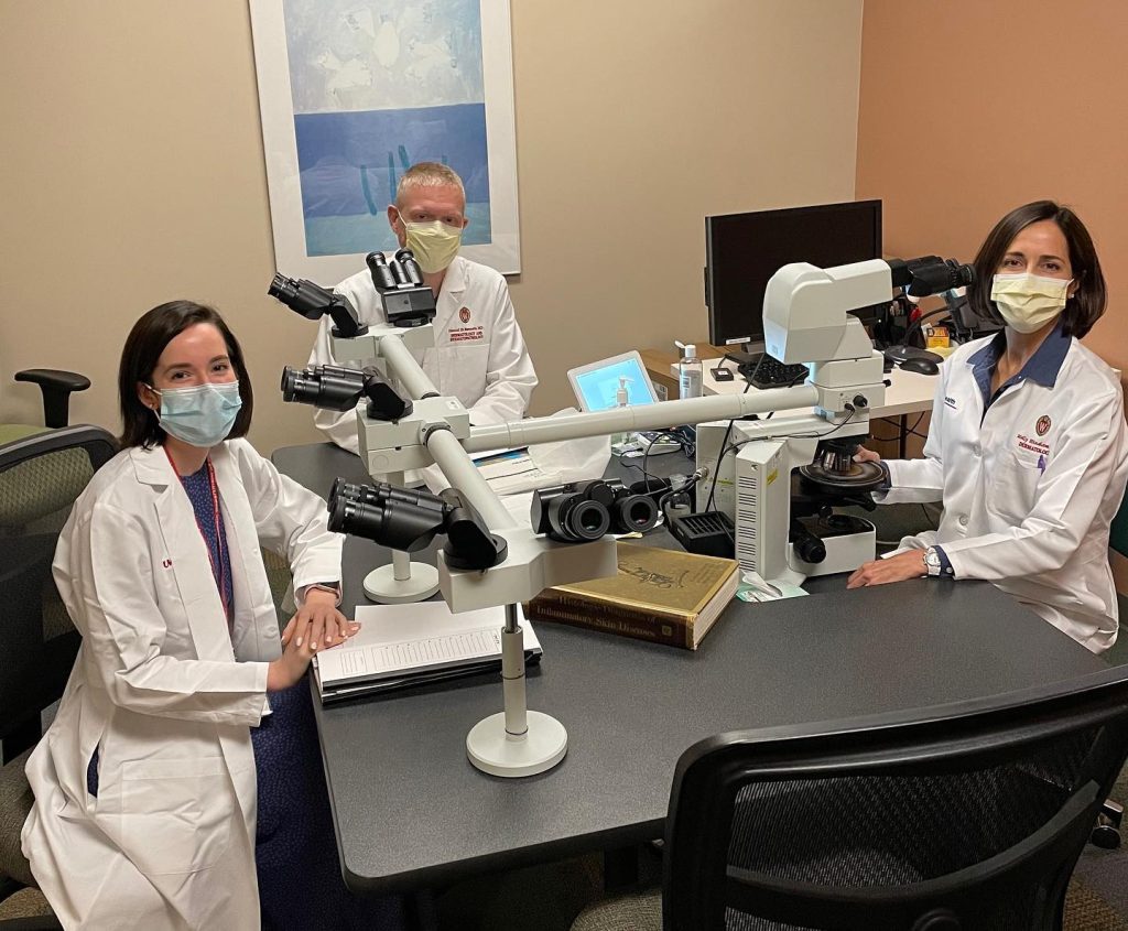 image of doctors at microscope station