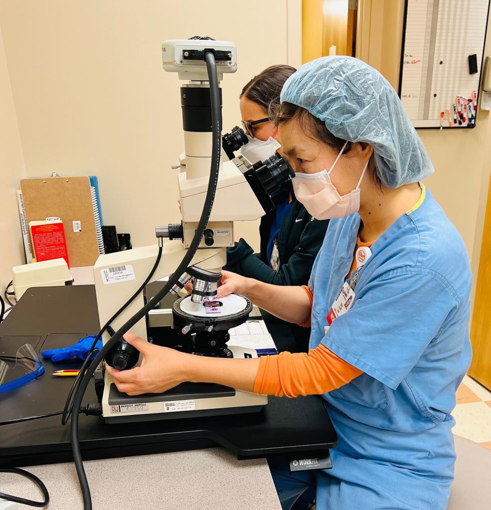 image of doctor at microscope